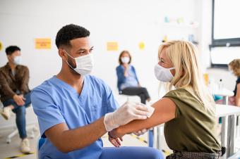 Health worker administering a vaccine to a patient