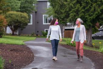 two women walking in a park in their neighborhood