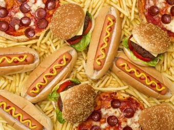 Highly processed food including hot dogs, pizza, cheeseburgers, and french fries