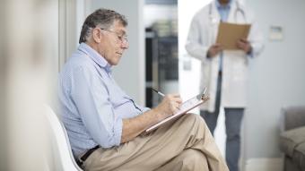 A man filling out a questionnaire at doc appointment