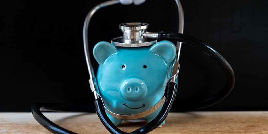 teal piggy bank with stethoscope