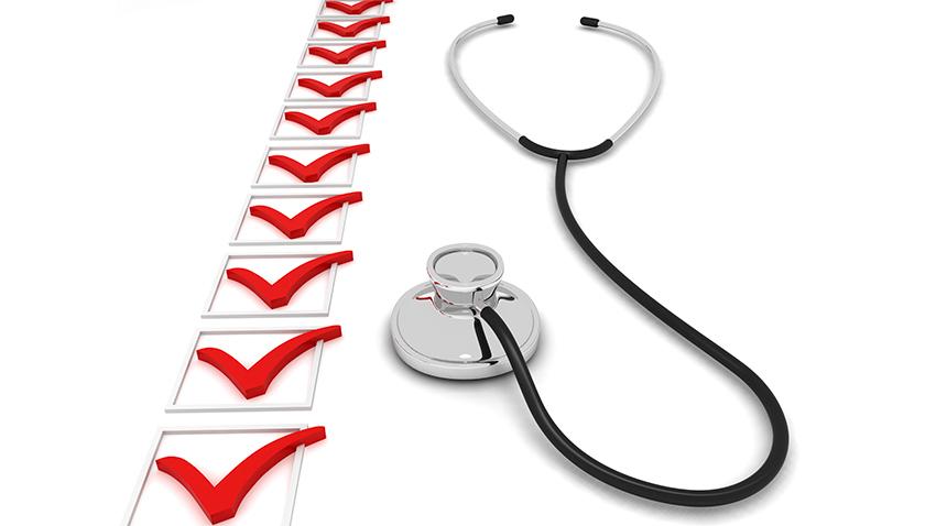 Stethoscope next to a checklist with red checkmarks
