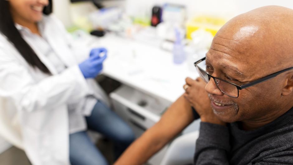 Older man getting a vaccine shot
