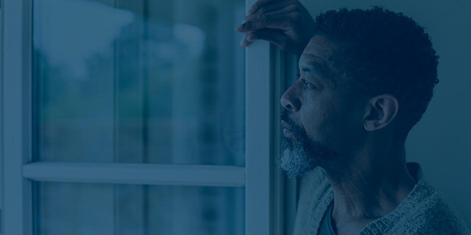 older man looking out of window